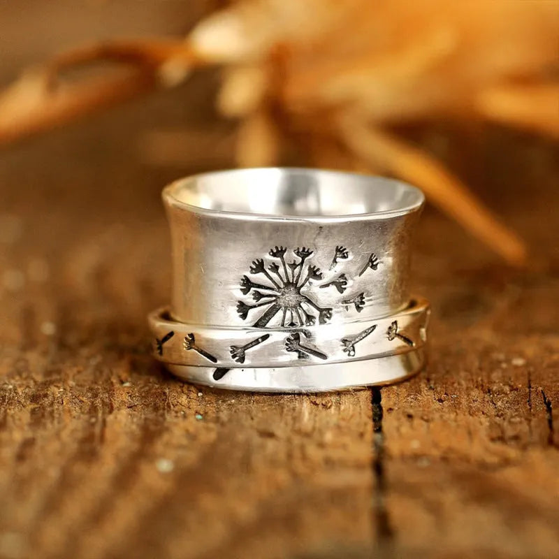 Silver colour rotatable flower ring on finger showing floral centrepiece