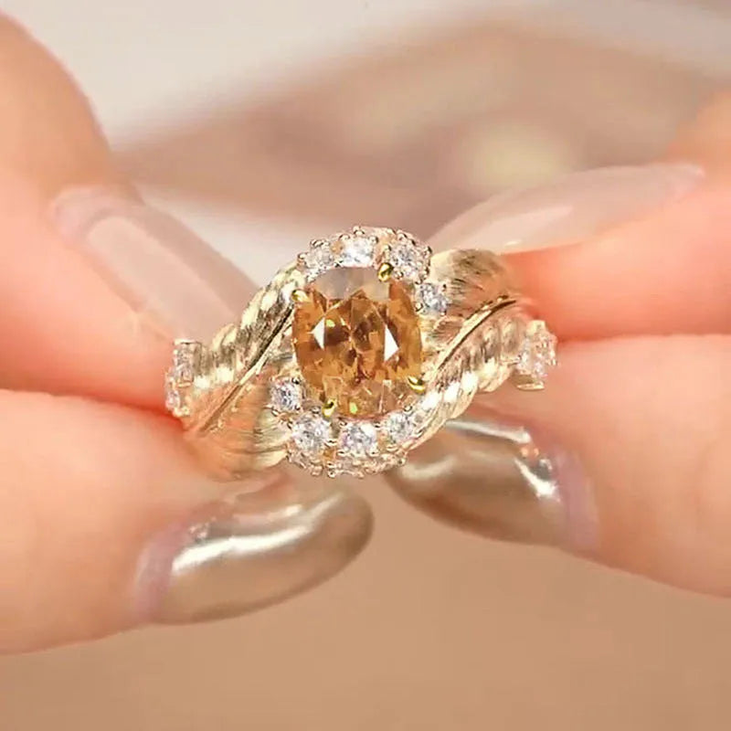 Gold-colour copper feather ring with embossed design and yellow zircon inlay on geometric shape