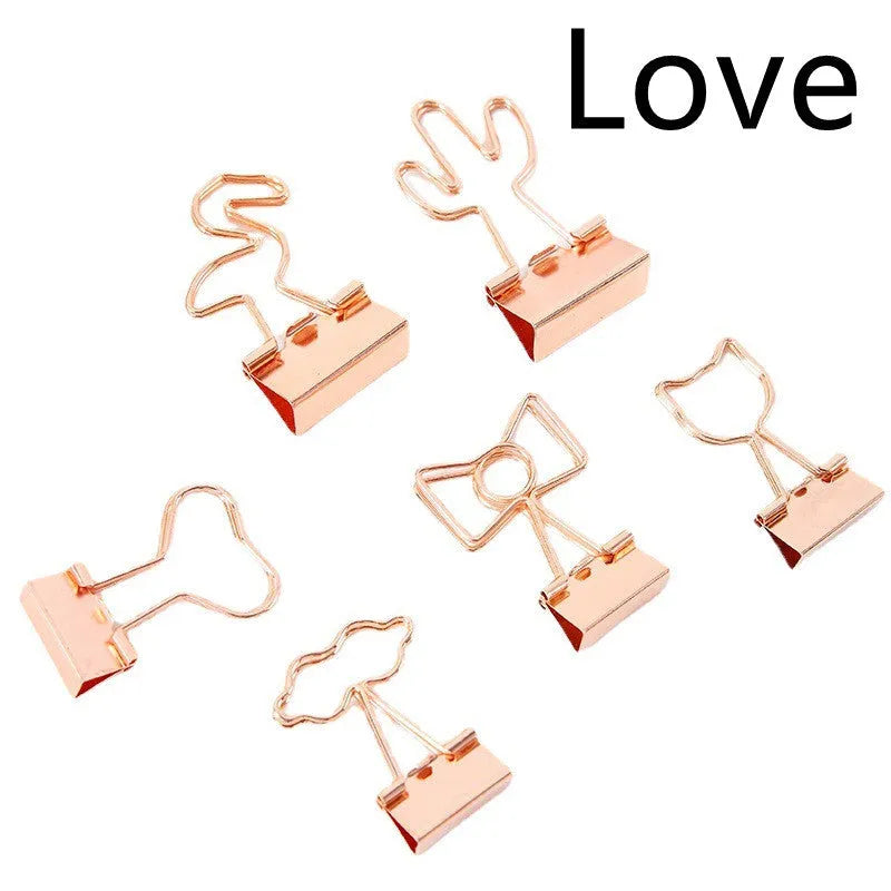 Gold-plated decorative binder clips showing flamingo, love, clouds, cat, cactus and bow designs