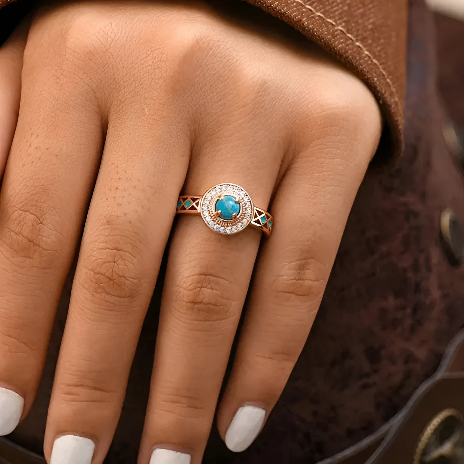 Women's rose gold coloured copper ring with geometric shape and inlaid turquoise zircon stones.