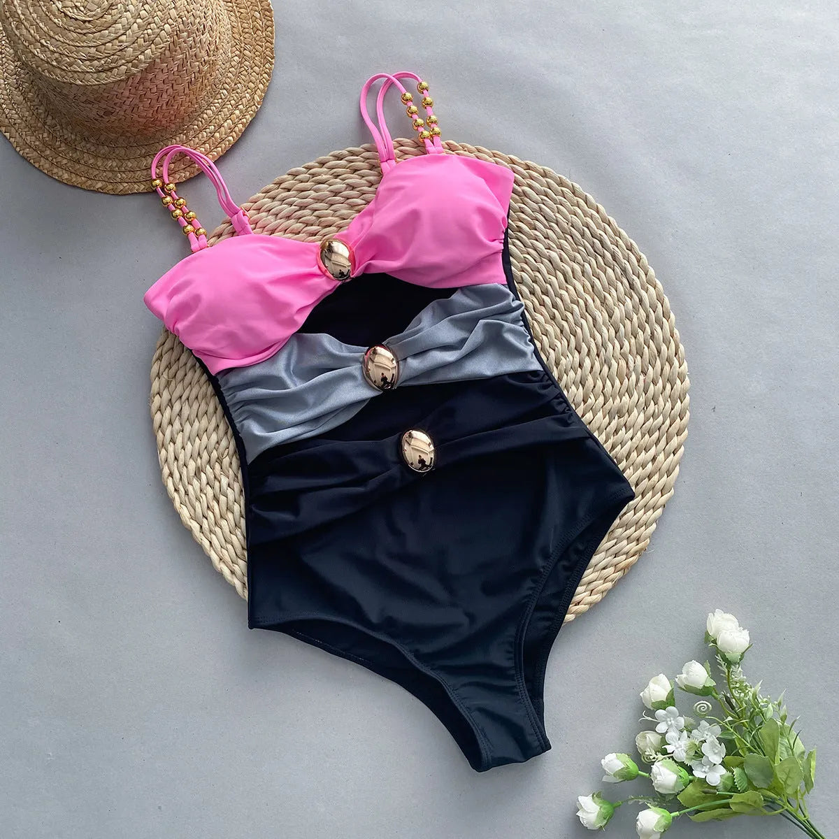 Women's brown one-piece swimsuit with matching beige skirt laid flat