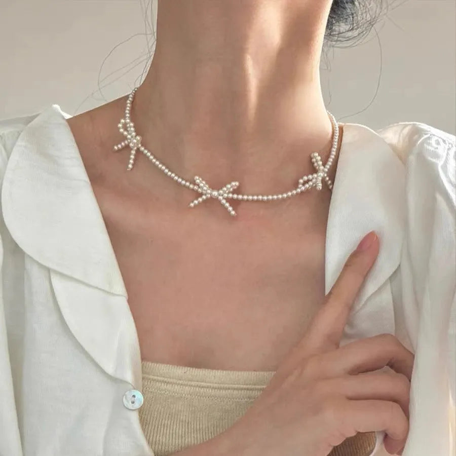 White sweet bow pearl necklace for women on an adjustable 31cm-40cm chain.