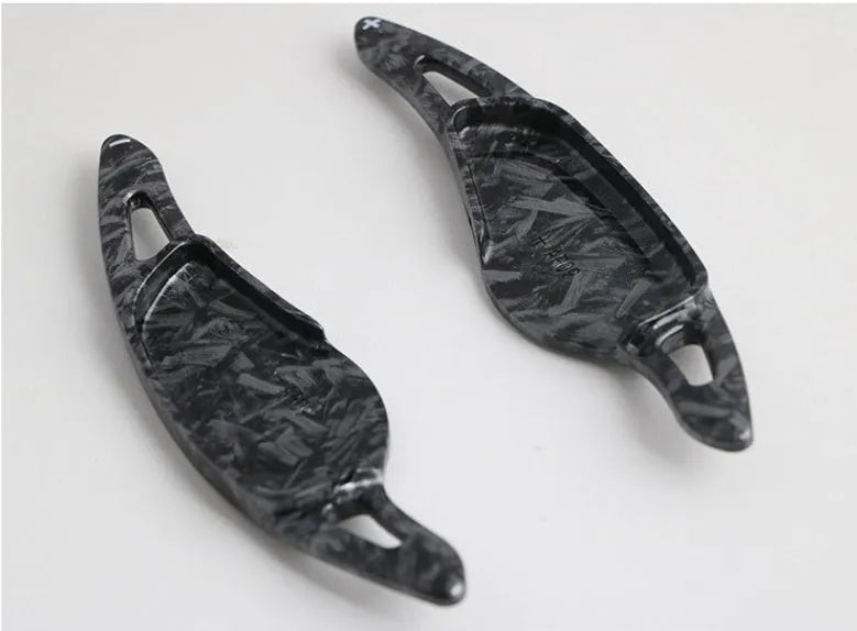 Steering wheel paddle shifter modification kit with carbon fibre pattern on black background