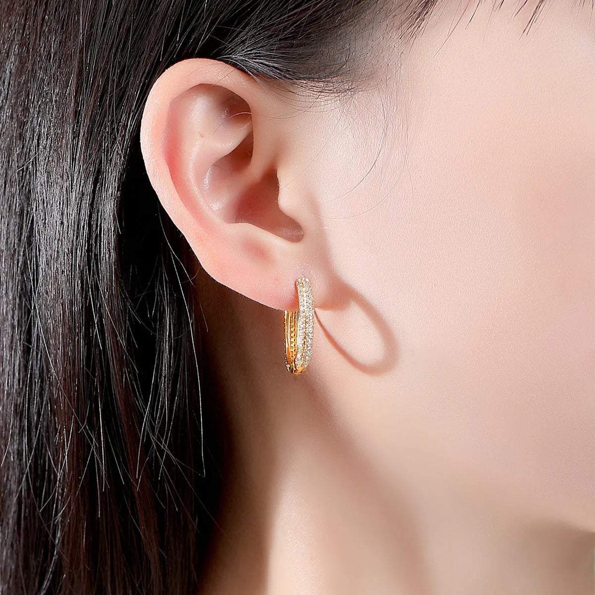 Pair of simple geometric copper earrings with electroplated finish in 18K gold option on white background