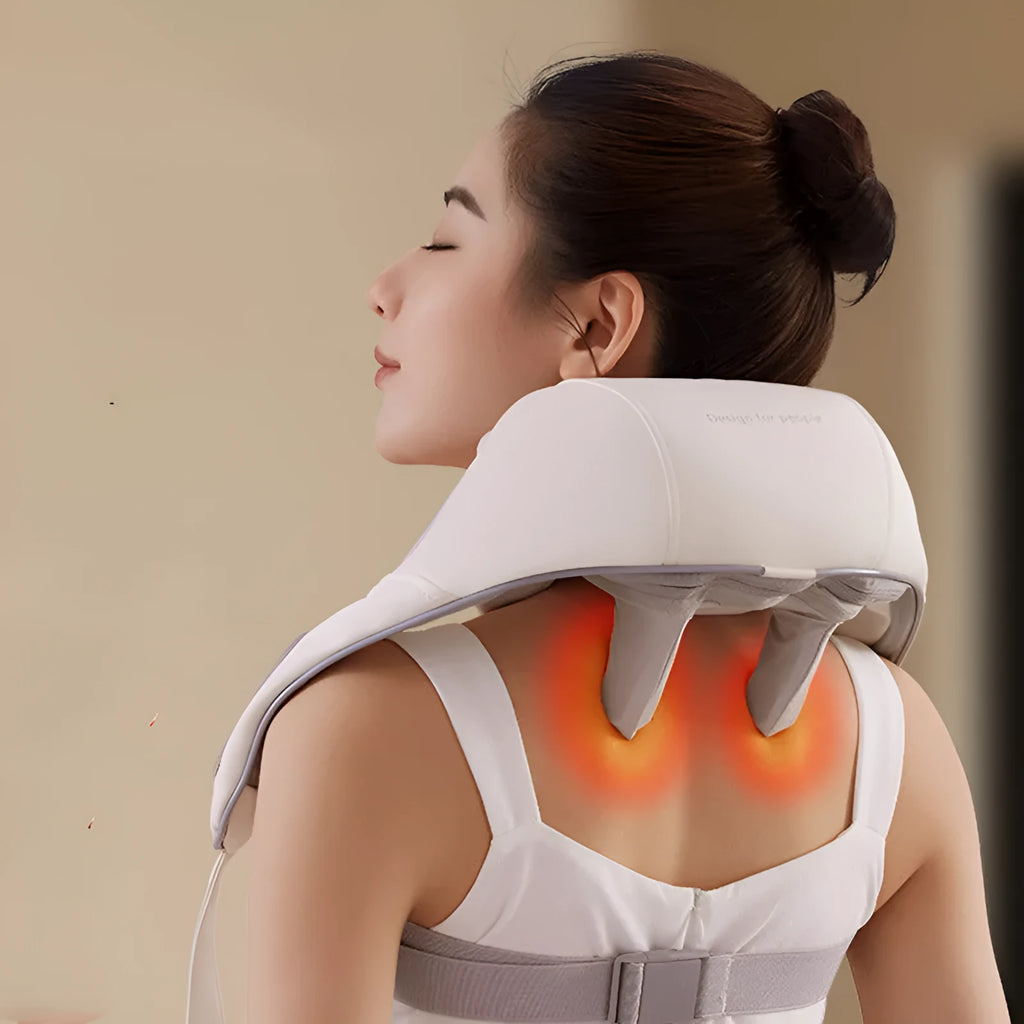 Beige electric shoulder and neck massager with clip-on kneading heads and half PU leather covering on a table