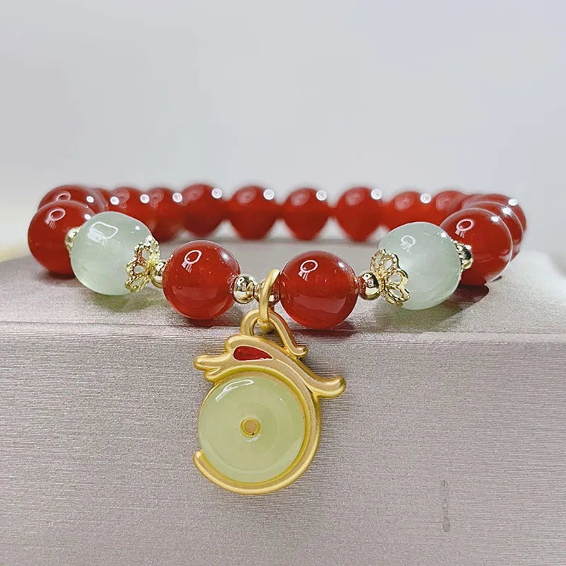 Handmade red agate bracelet with dragon and lucky bag Chinese designs for women.