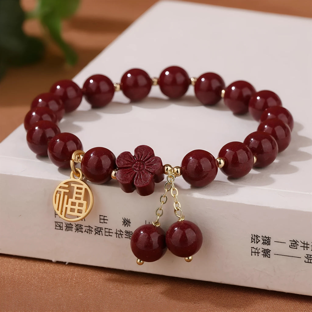 Traditional cinnabar women's bracelet with fu character centrepiece in purple and gold sand colours