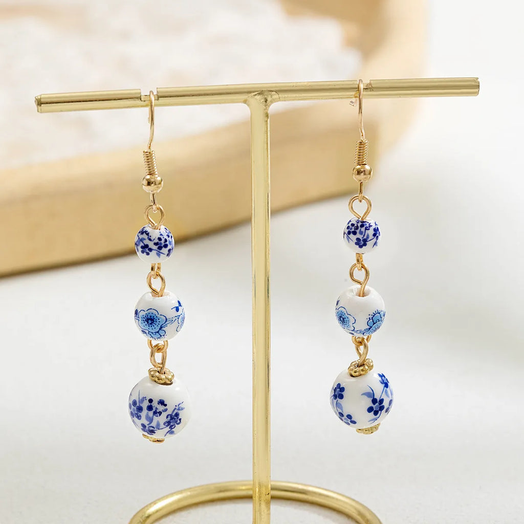 Blue and white porcelain ceramic bead long retro earrings with geometric round design and alloy electroplated finish