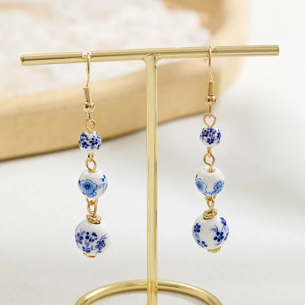 Blue and white porcelain ceramic bead long retro earrings with geometric round design and alloy electroplated finish