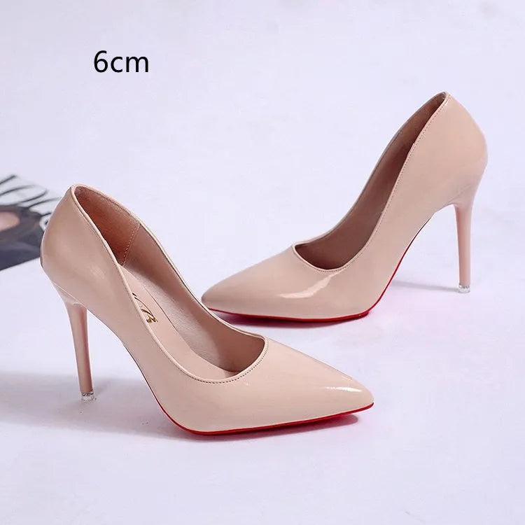 Women's black pointed toe stiletto pumps with a low-cut vamp and thin high heel on a white background.