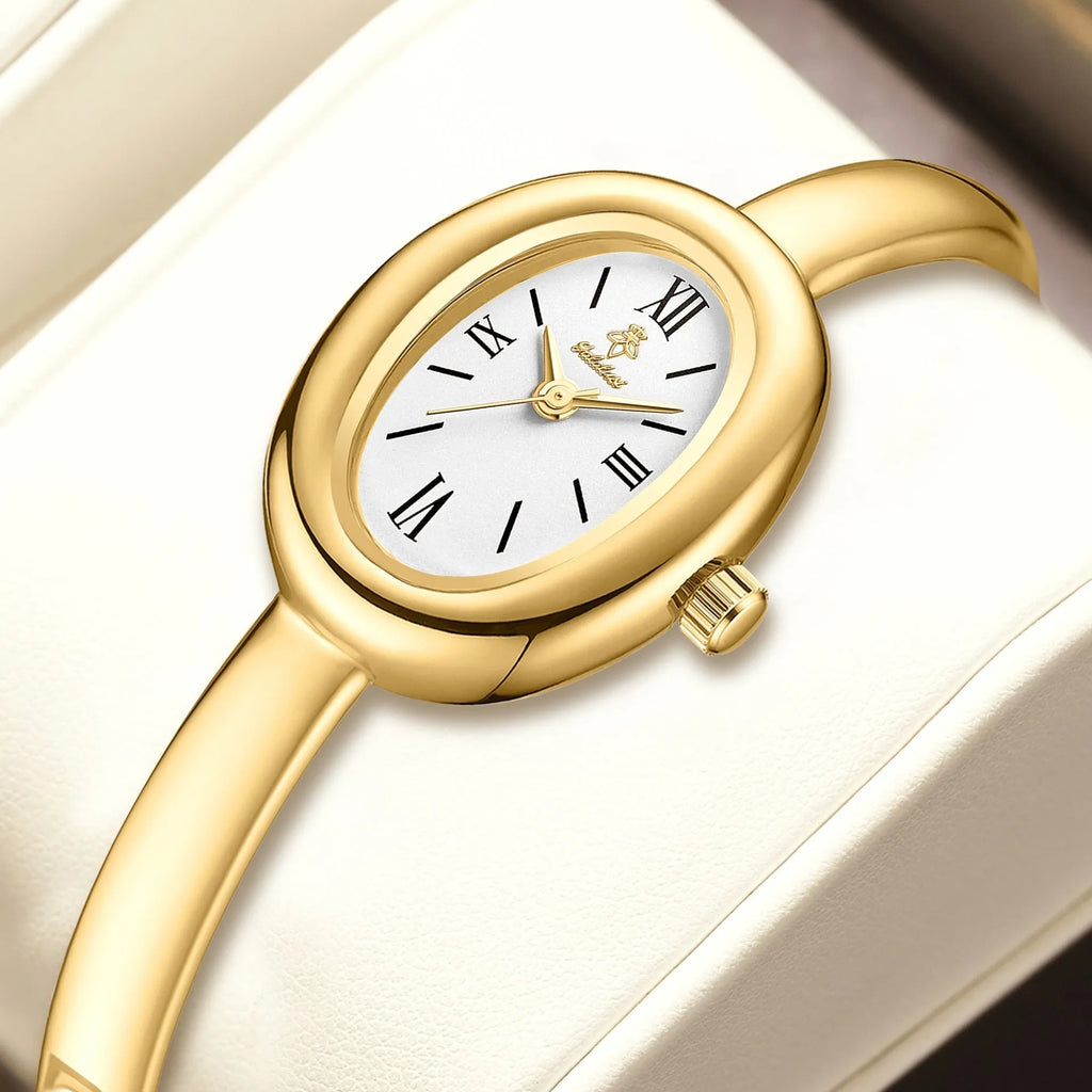 Women's slim oval retro quartz watch in gold colour on wrist