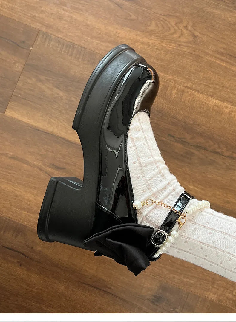 Beige and black women's Mary Jane shoes with a chunky heel and round toe.